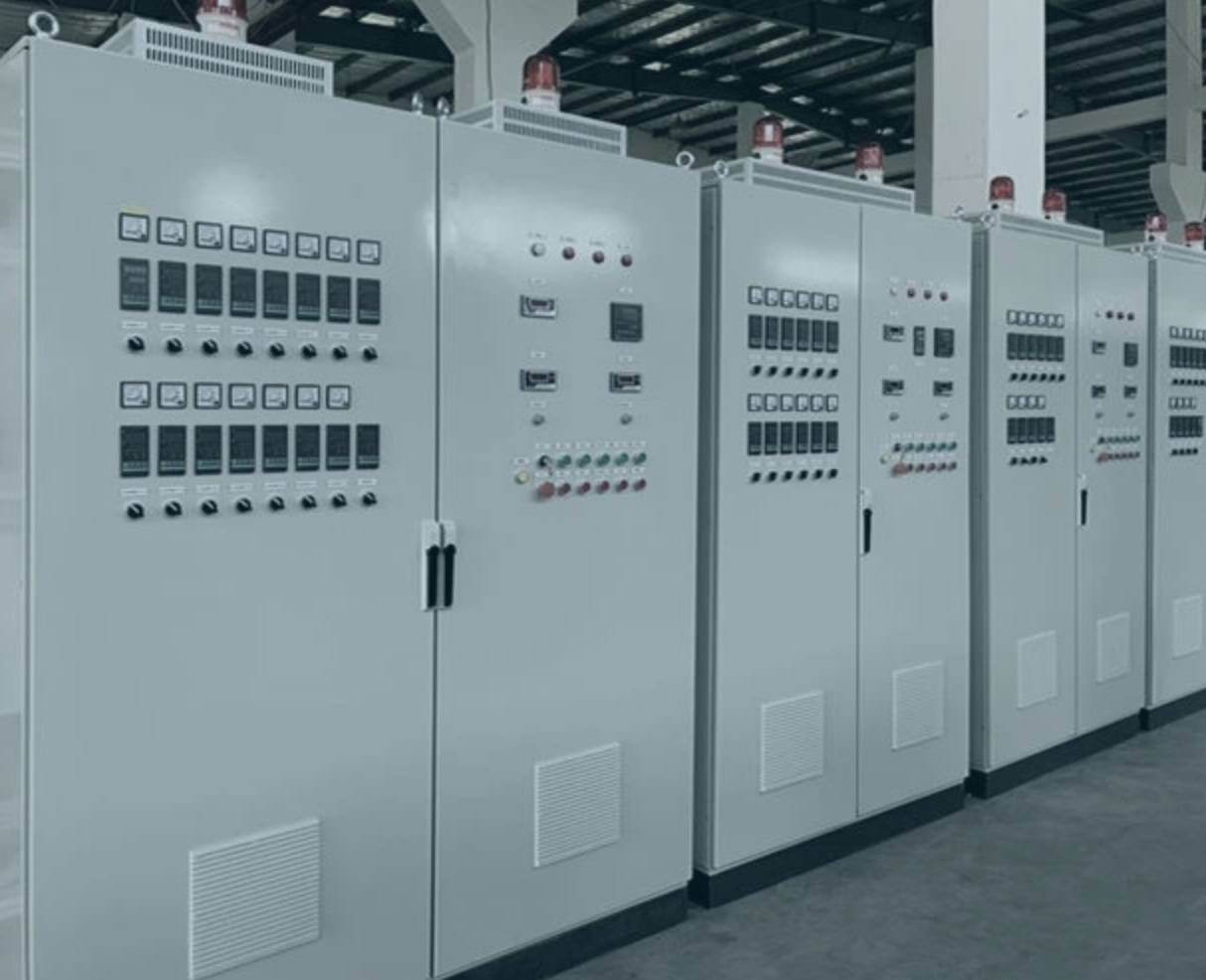 Row of grey control panels with door-mounted instruments